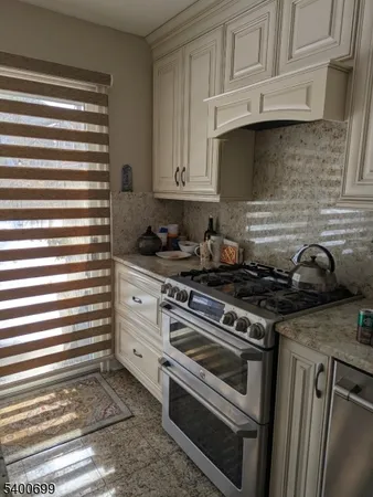 a kitchen with white cabinets and appliances