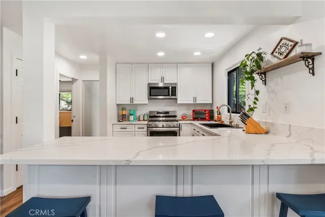 a kitchen with sink cabinets and appliances