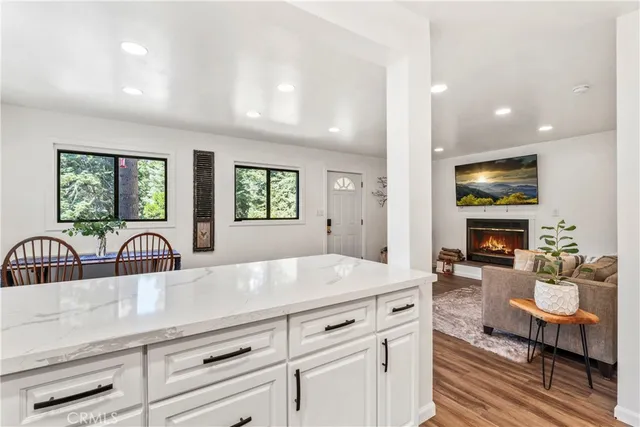 a view of living room kitchen with stainless steel appliances cabinets