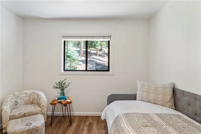 a view of a hallway with entryway and wooden floor