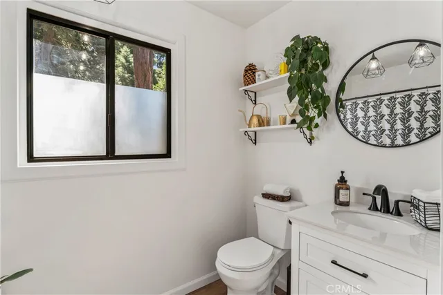 a bathroom with a toilet and a shower curtain