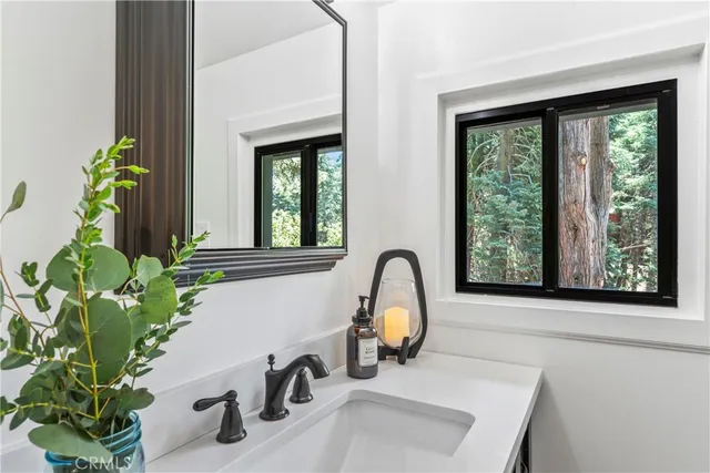 a view of livingroom with furniture flat screen tv and floor to ceiling window