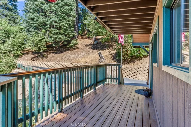a view of a house with a yard and wooden fence
