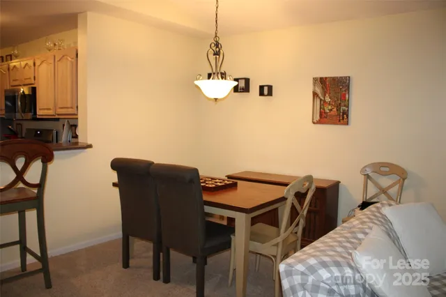 a view of a room that has a table and chairs in it