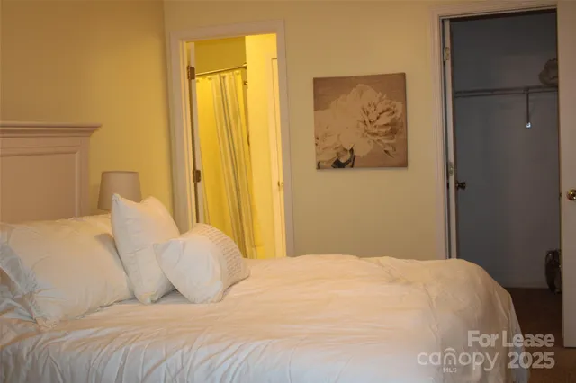 a bedroom with a bed and a painting on the wall