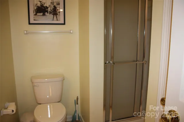 a white toilet sitting next to a small bathroom