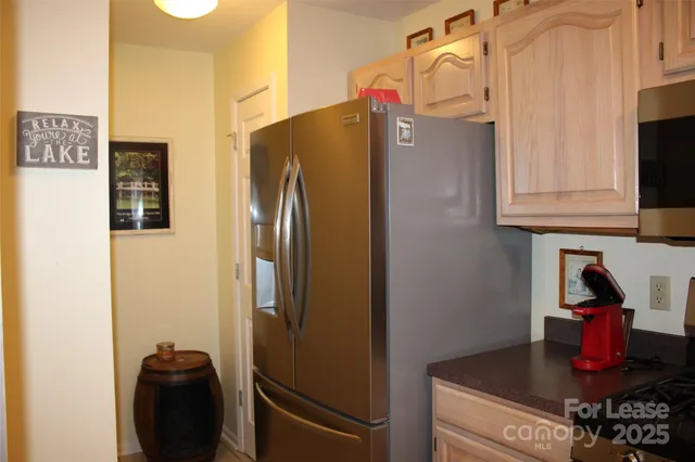 a kitchen with stainless steel appliances granite countertop a refrigerator and a stove