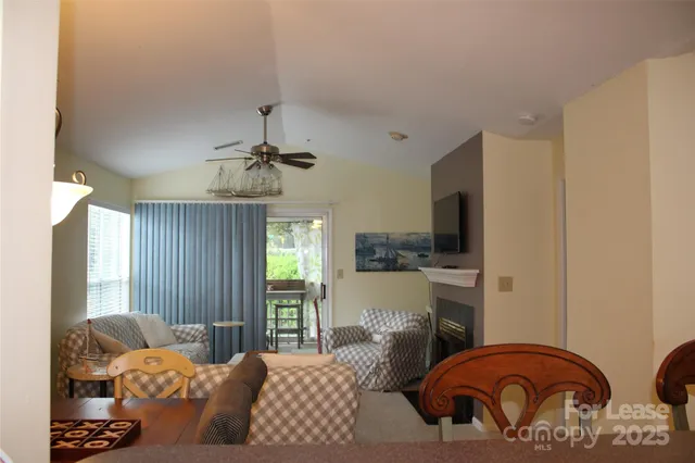a bedroom with furniture a ceiling fan and a rug