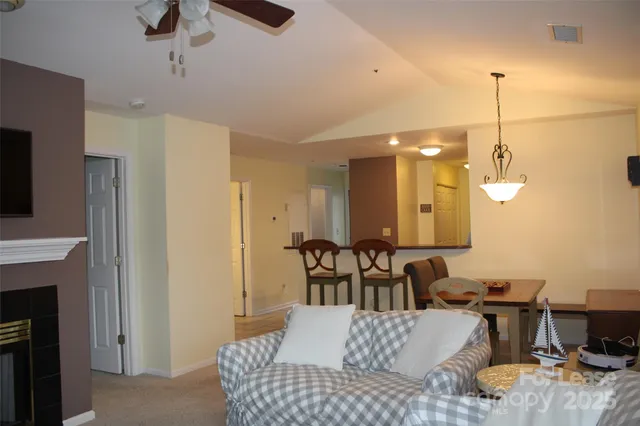 a view of a livingroom with furniture and a ceiling fan
