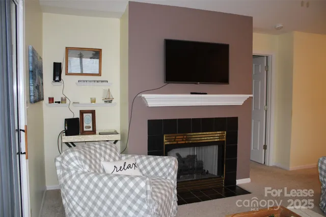 a living room with a fireplace and a flat screen tv