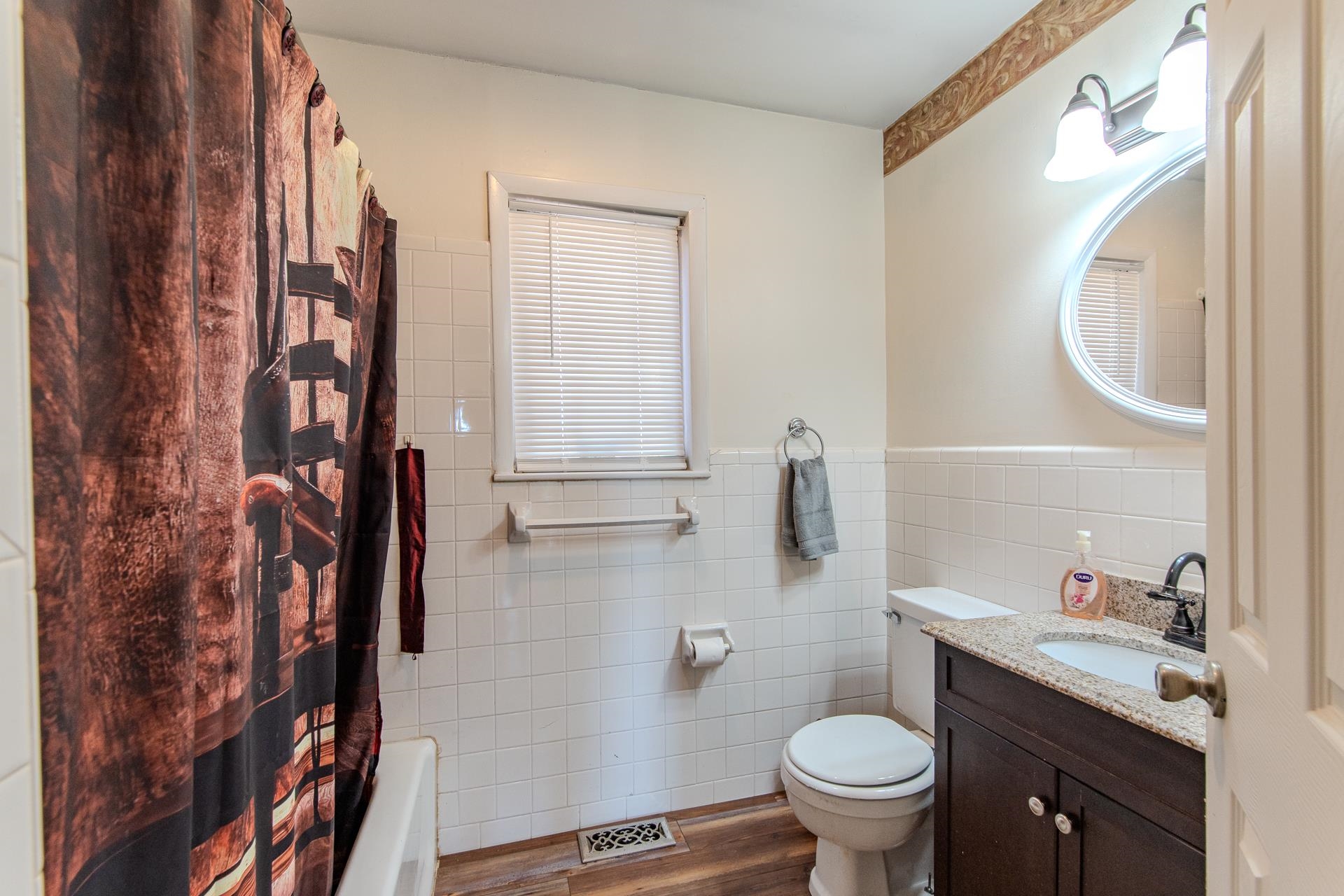 3540 Damon Road Michie, TN 38357 - Photo 12 of 40 a bathroom with a granite countertop toilet sink and mirror