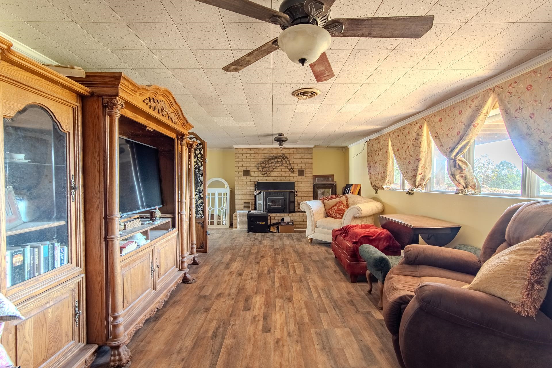 3540 Damon Road Michie, TN 38357 - Photo 18 of 40 a living room with furniture a fireplace and a chandelier