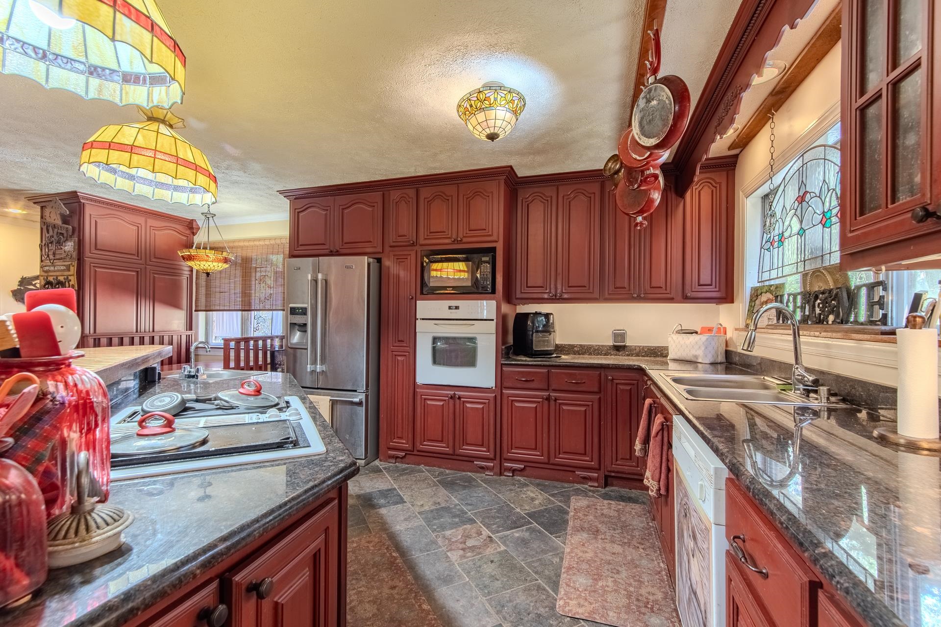 3540 Damon Road Michie, TN 38357 - Photo 6 of 40 a kitchen with stainless steel appliances granite countertop a stove refrigerator and cabinets