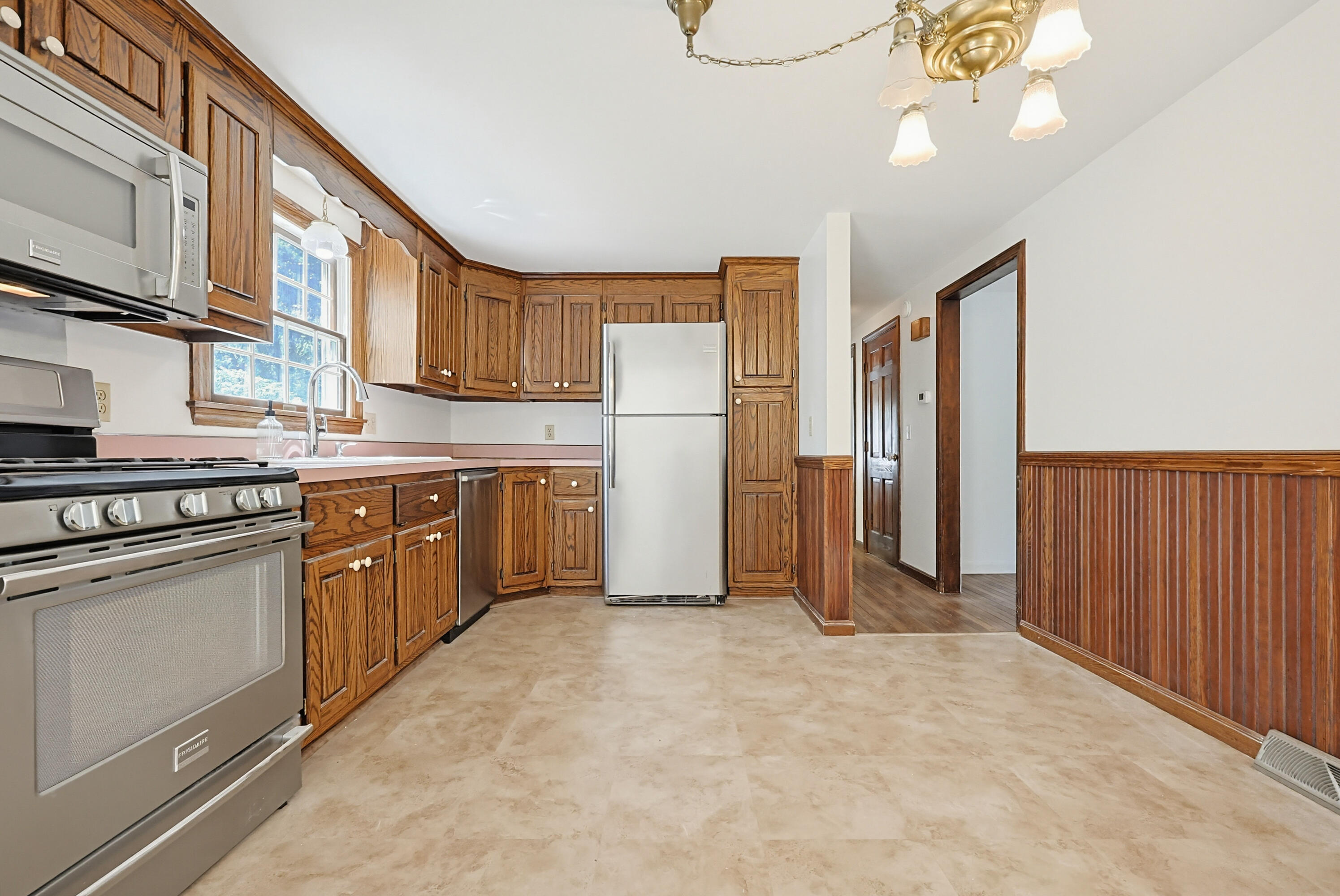 556 Cotuit Road Mashpee, MA 02649 - Photo 16 of 45 a kitchen with stainless steel appliances granite countertop a refrigerator sink and cabinets
