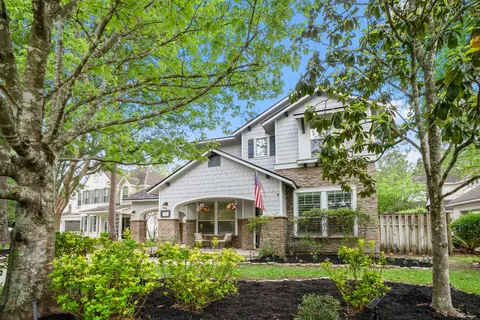 a front view of a house with a garden