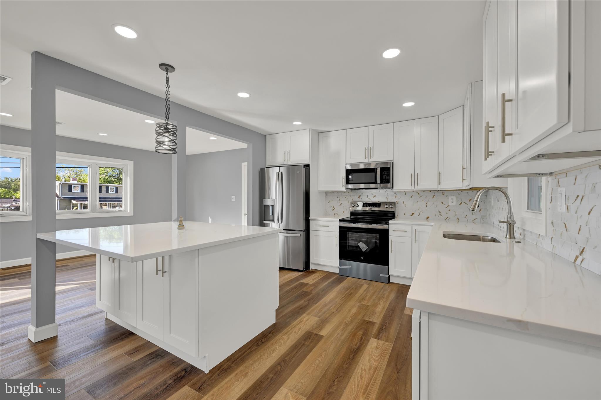 2 Armor Court Baltimore, MD 21220 - Photo 13 of 33 a large kitchen with cabinets wooden floor and stainless steel appliances