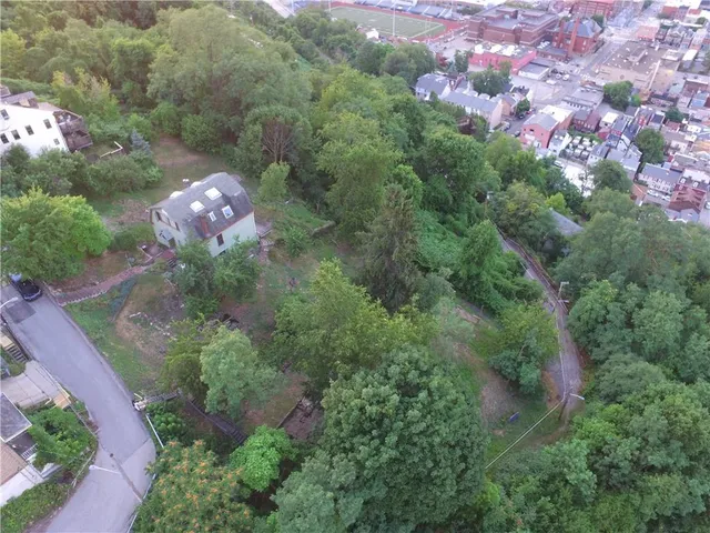 an aerial view of a house with a yard