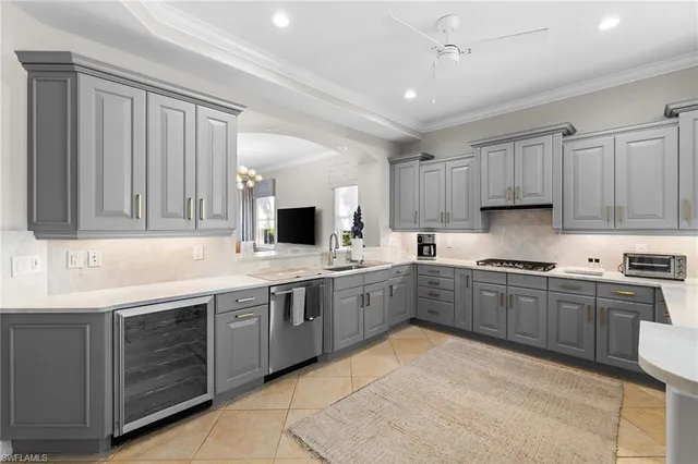 a kitchen with granite countertop sink window and white stainless steel appliances
