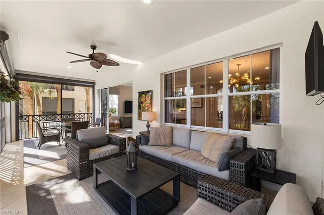 a living room with furniture and large windows