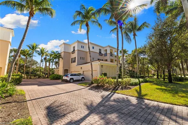 a row of palm trees and swimming pool in the backyard of a house