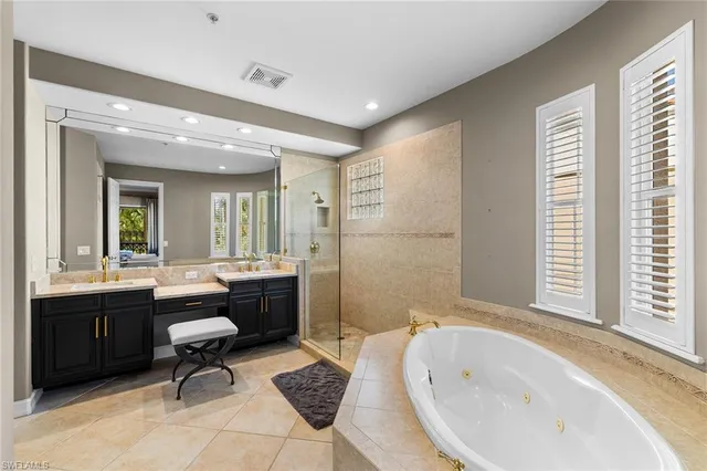 a bathroom with a granite countertop sink a toilet a mirror and shower