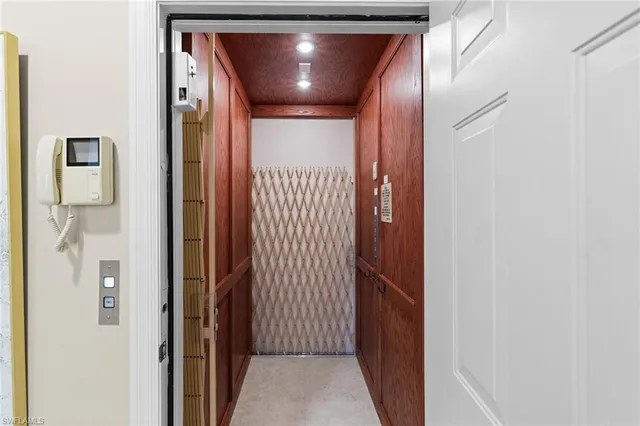 a bedroom with a bed a mirror and a window