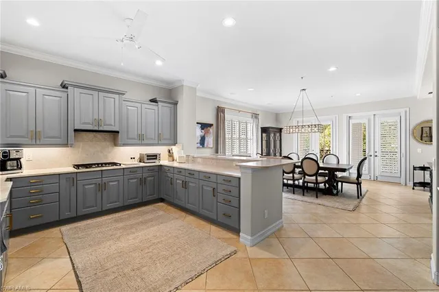 a kitchen with granite countertop a sink cabinets and stainless steel appliances