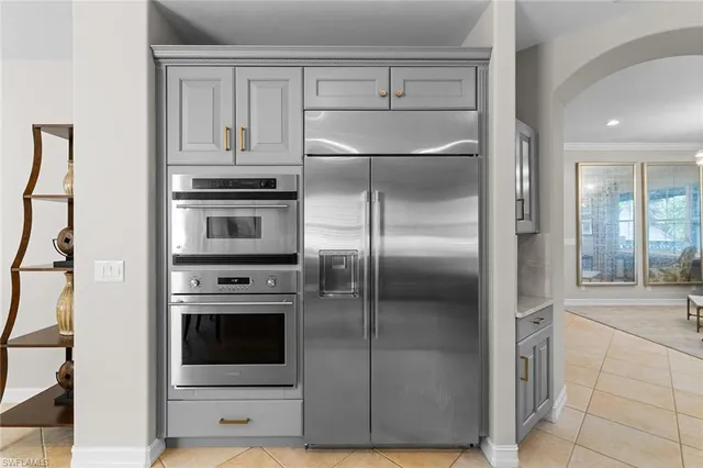 a kitchen with cabinets and stainless steel appliances
