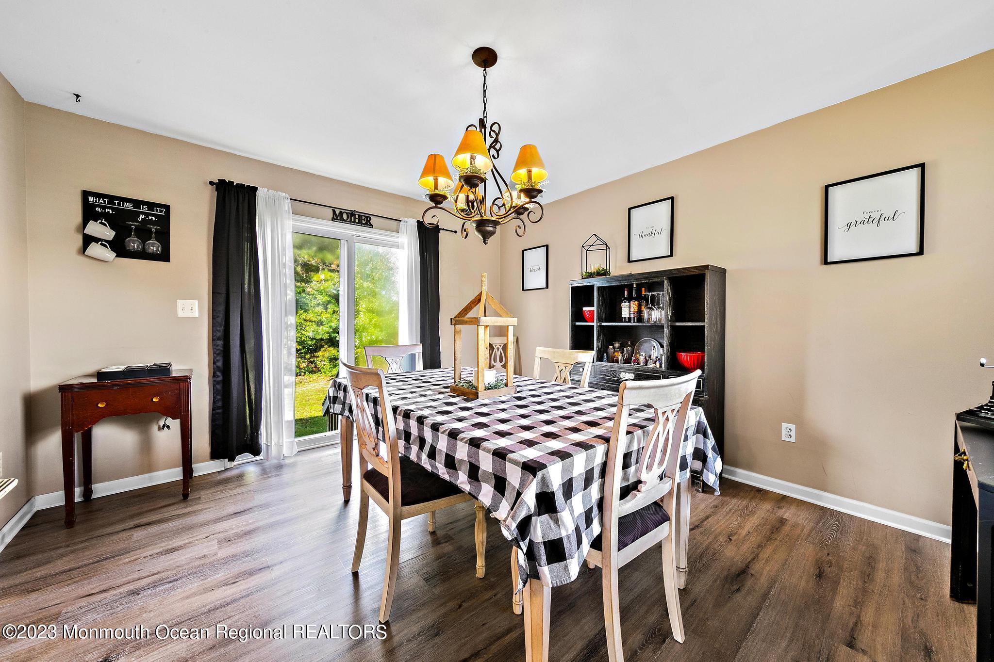 5 Stonegate Drive Little Egg Harbor, NJ 08087 - Photo 11 of 36 a view of a dining room with furniture wooden floor and chandelier