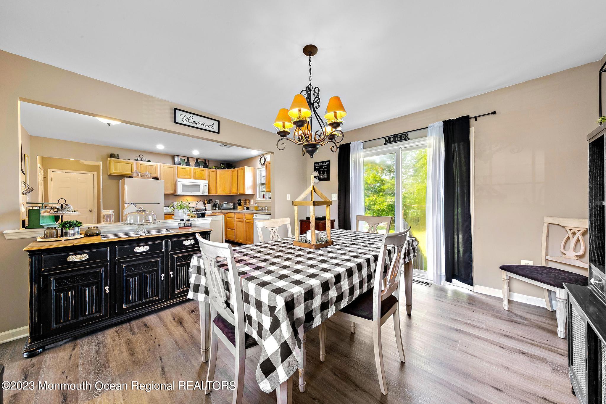 5 Stonegate Drive Little Egg Harbor, NJ 08087 - Photo 12 of 36 a view of a dining room with furniture wooden floor and chandelier