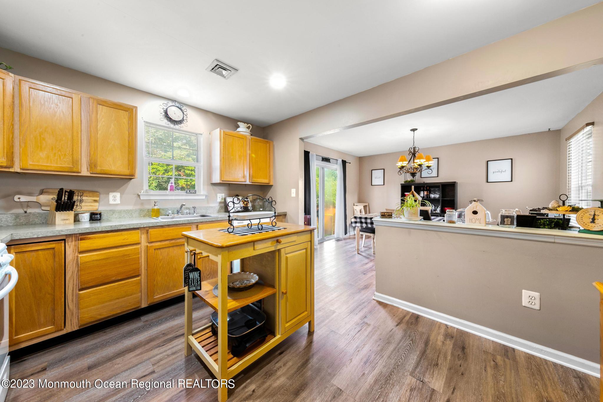 5 Stonegate Drive Little Egg Harbor, NJ 08087 - Photo 15 of 36 a kitchen with stainless steel appliances granite countertop a sink a stove a refrigerator cabinets and living room view