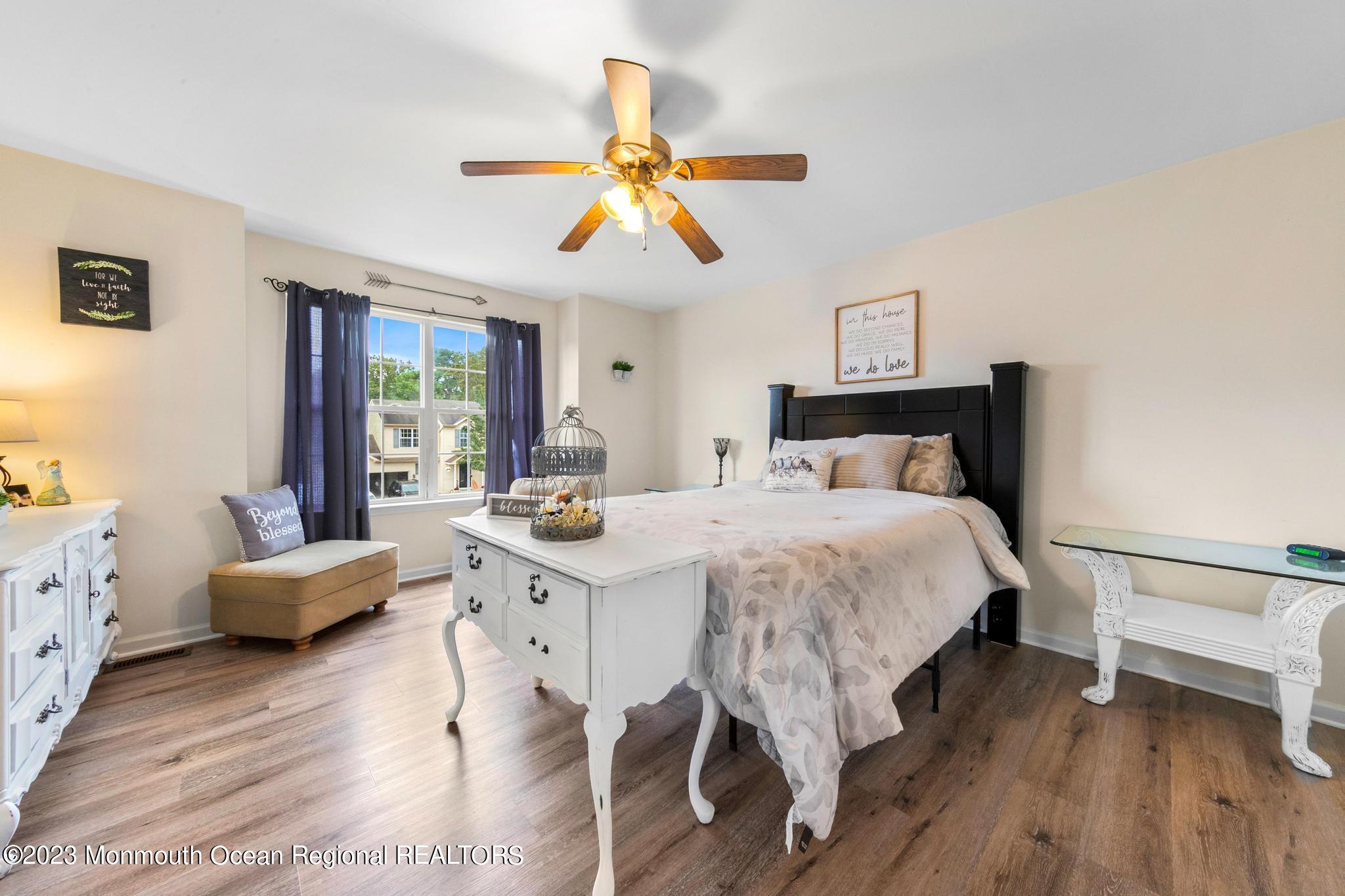 5 Stonegate Drive Little Egg Harbor, NJ 08087 - Photo 20 of 36 a bedroom with a bed and a chandelier