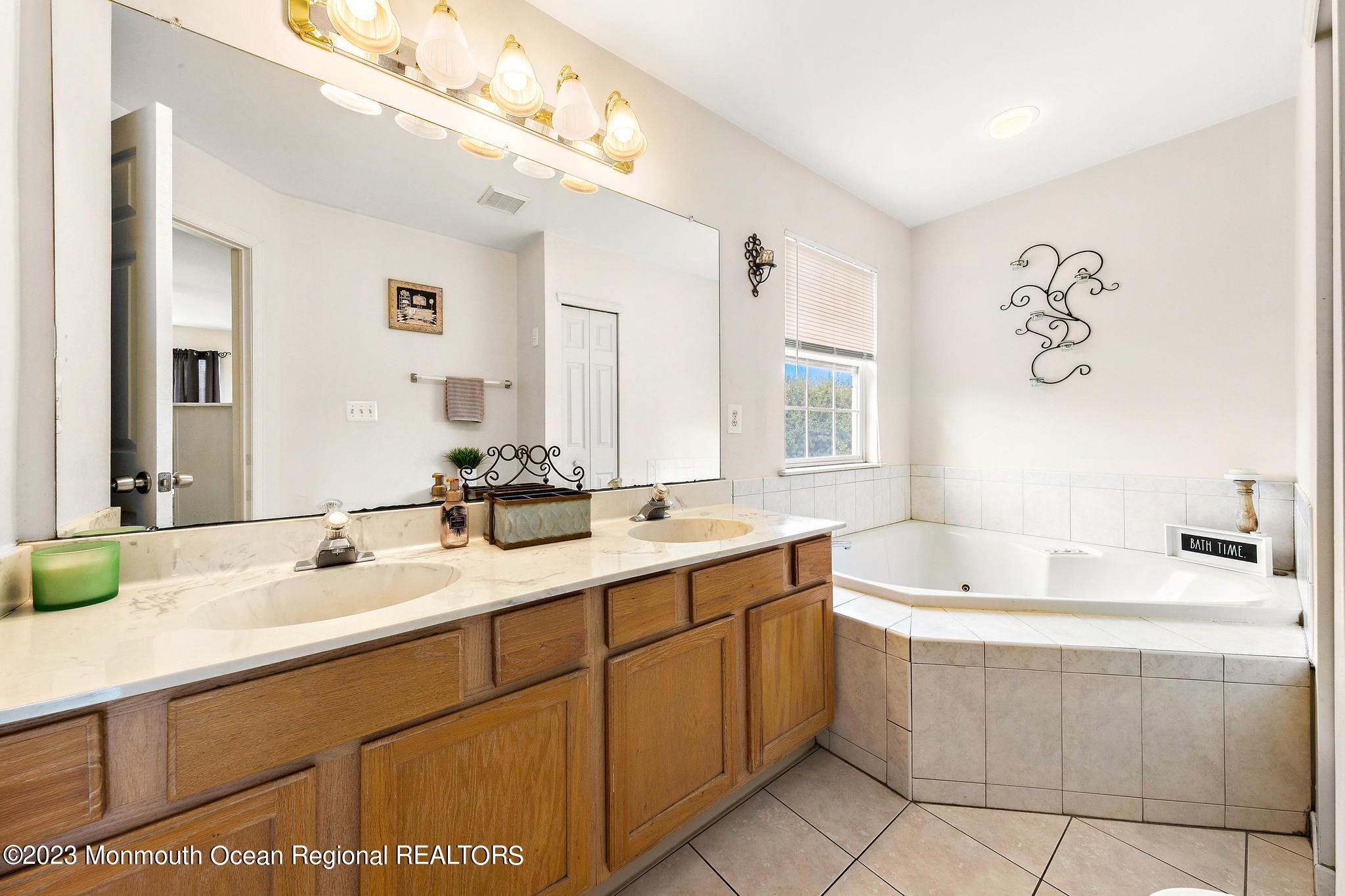 5 Stonegate Drive Little Egg Harbor, NJ 08087 - Photo 24 of 36 a bathroom with a double vanity sink mirror and bathtub