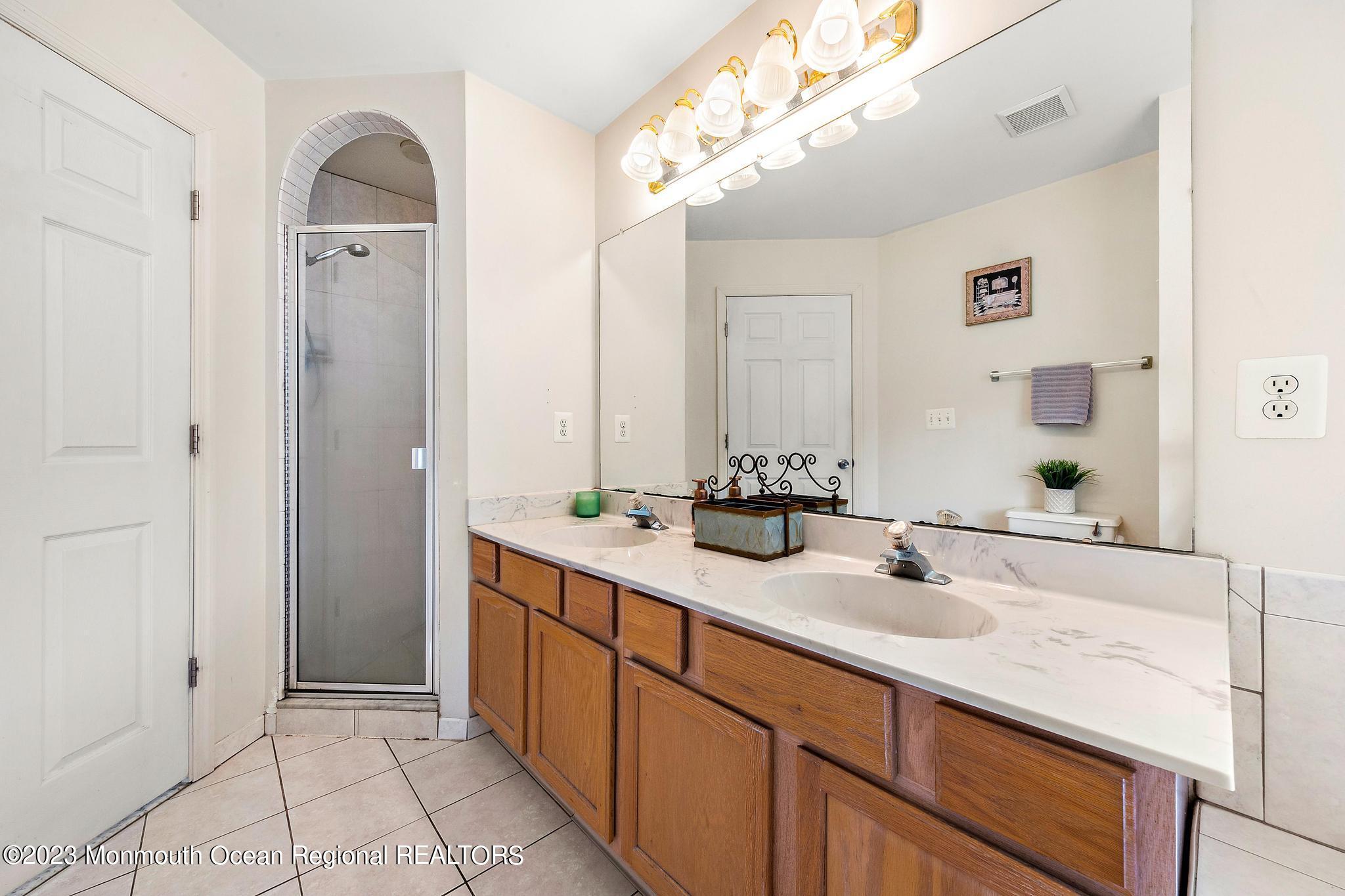 5 Stonegate Drive Little Egg Harbor, NJ 08087 - Photo 25 of 36 a bathroom with a double vanity sink and a mirror