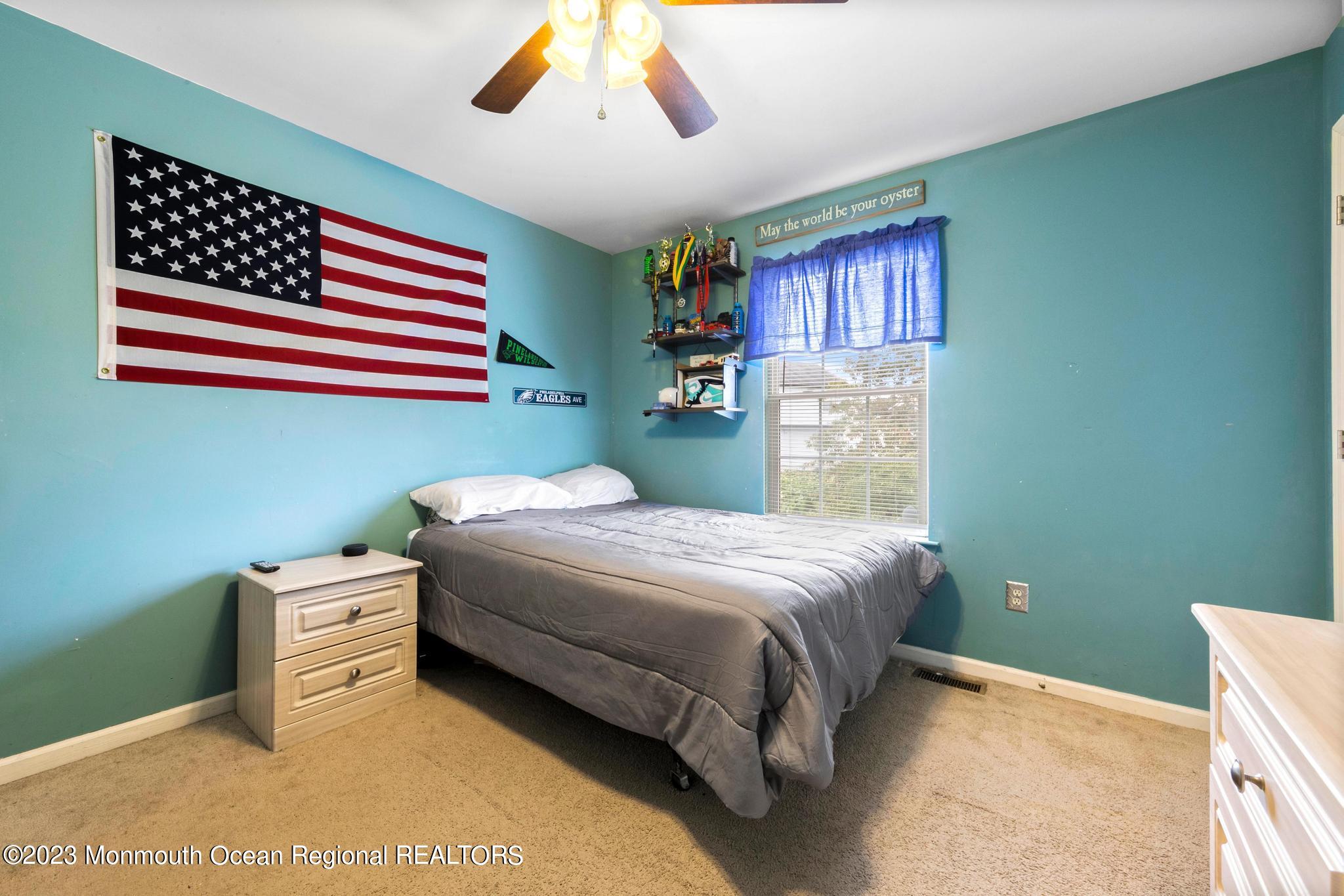 5 Stonegate Drive Little Egg Harbor, NJ 08087 - Photo 27 of 36 a bedroom with a bed and a chandelier