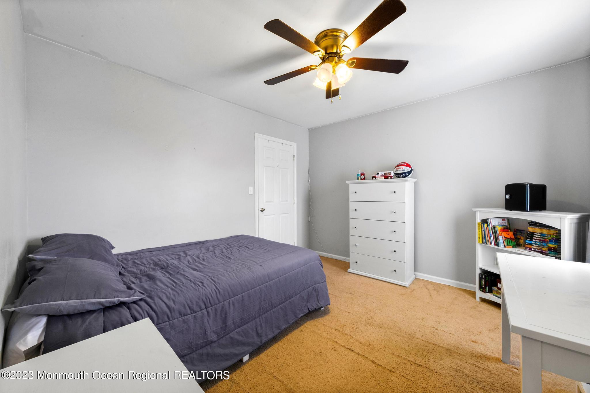 5 Stonegate Drive Little Egg Harbor, NJ 08087 - Photo 28 of 36 a bedroom with a bed and a chandelier