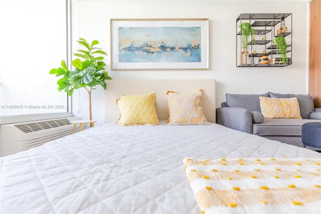 a bedroom with a bed and a painting on the wall