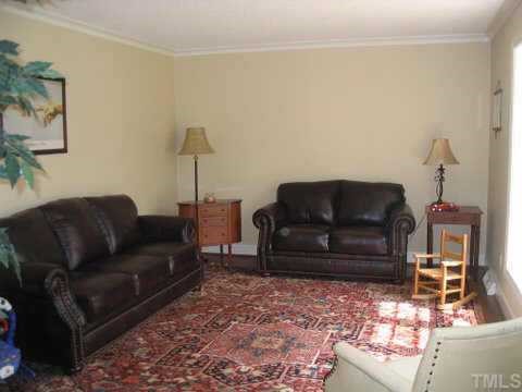 7405 Baystone Court Raleigh, NC 27615 - Photo 3 of 10 a living room with furniture and a couch
