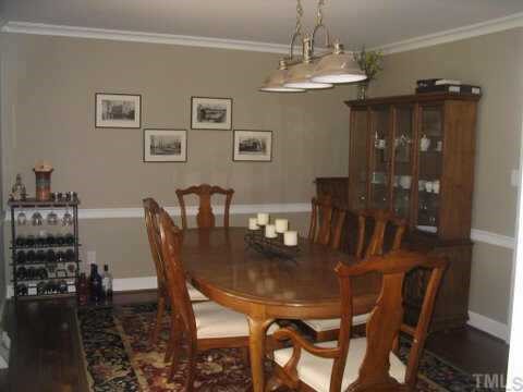 7405 Baystone Court Raleigh, NC 27615 - Photo 4 of 10 a view of a dining room with furniture and wooden floor