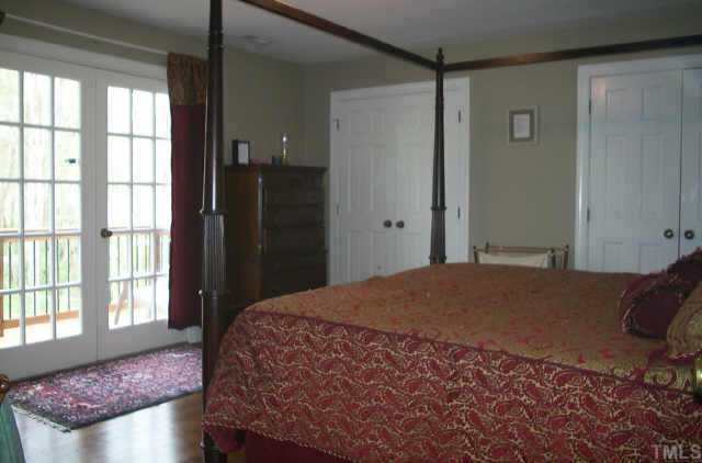 7405 Baystone Court Raleigh, NC 27615 - Photo 8 of 10 a bedroom with a bed and a window
