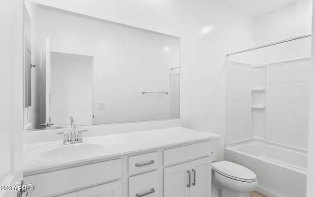 a bathroom with a sink a toilet and a large mirror