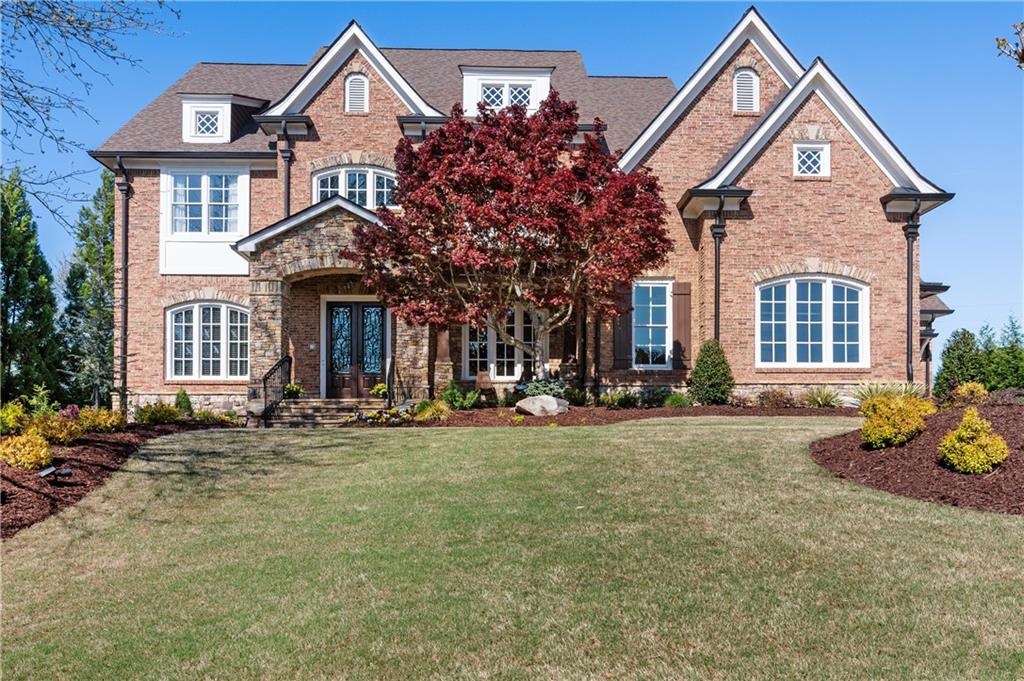 15839 Winterfield Way Milton, GA 30004 - Photo 1 of 1 a front view of a house with outdoor seating and a yard