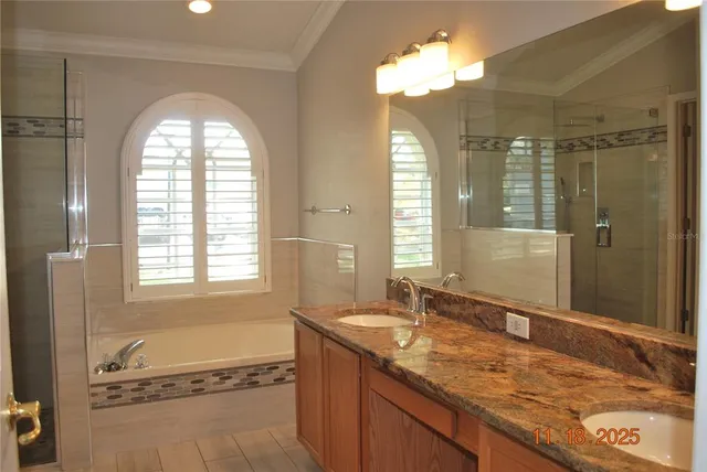 a spacious bathroom with a granite countertop sink mirror and a shower