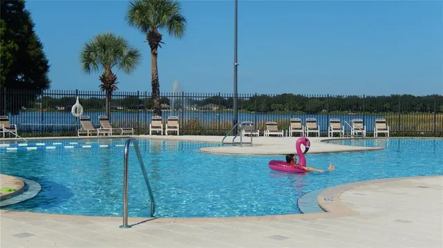 a park view with a swimming pool and lake view