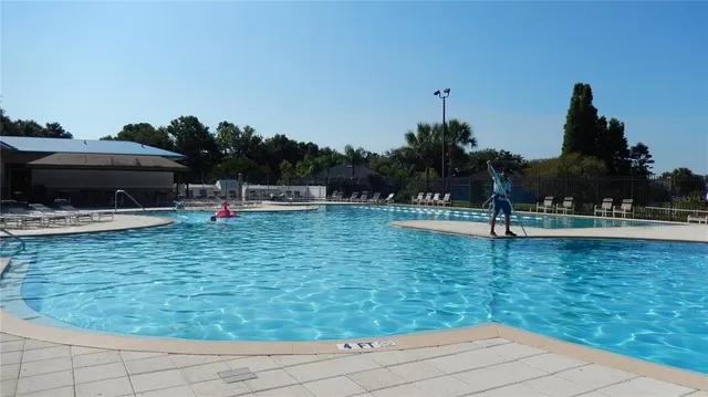 a view of swimming pool with a yard