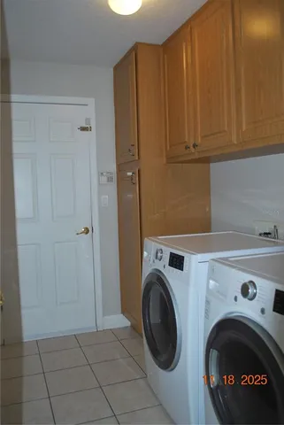a view of storage and utility room with washer and dryer