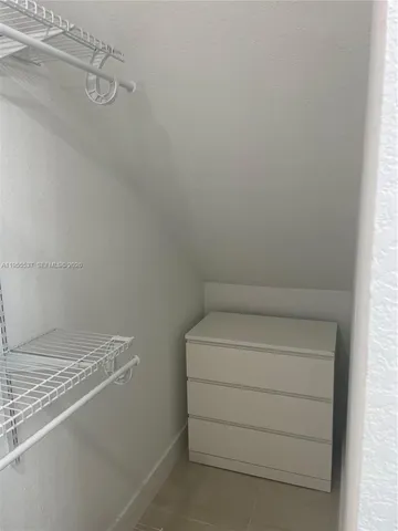 a bathroom with a granite countertop sink and mirror