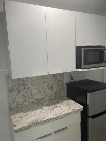 a kitchen with a sink and a microwave
