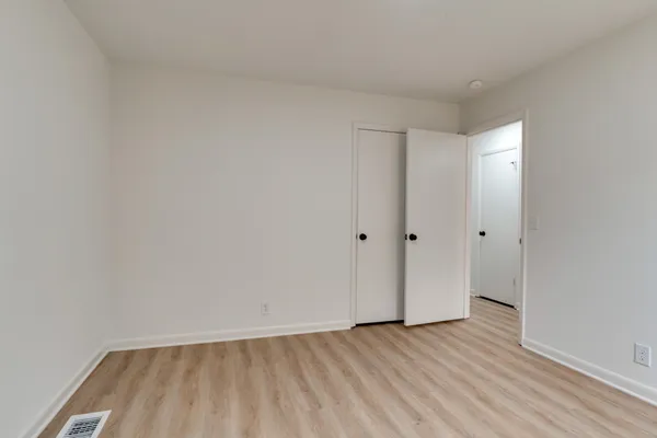 a view of an empty room and wooden floor