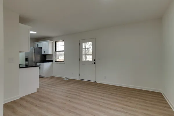 a view of a kitchen with wooden floor and windows